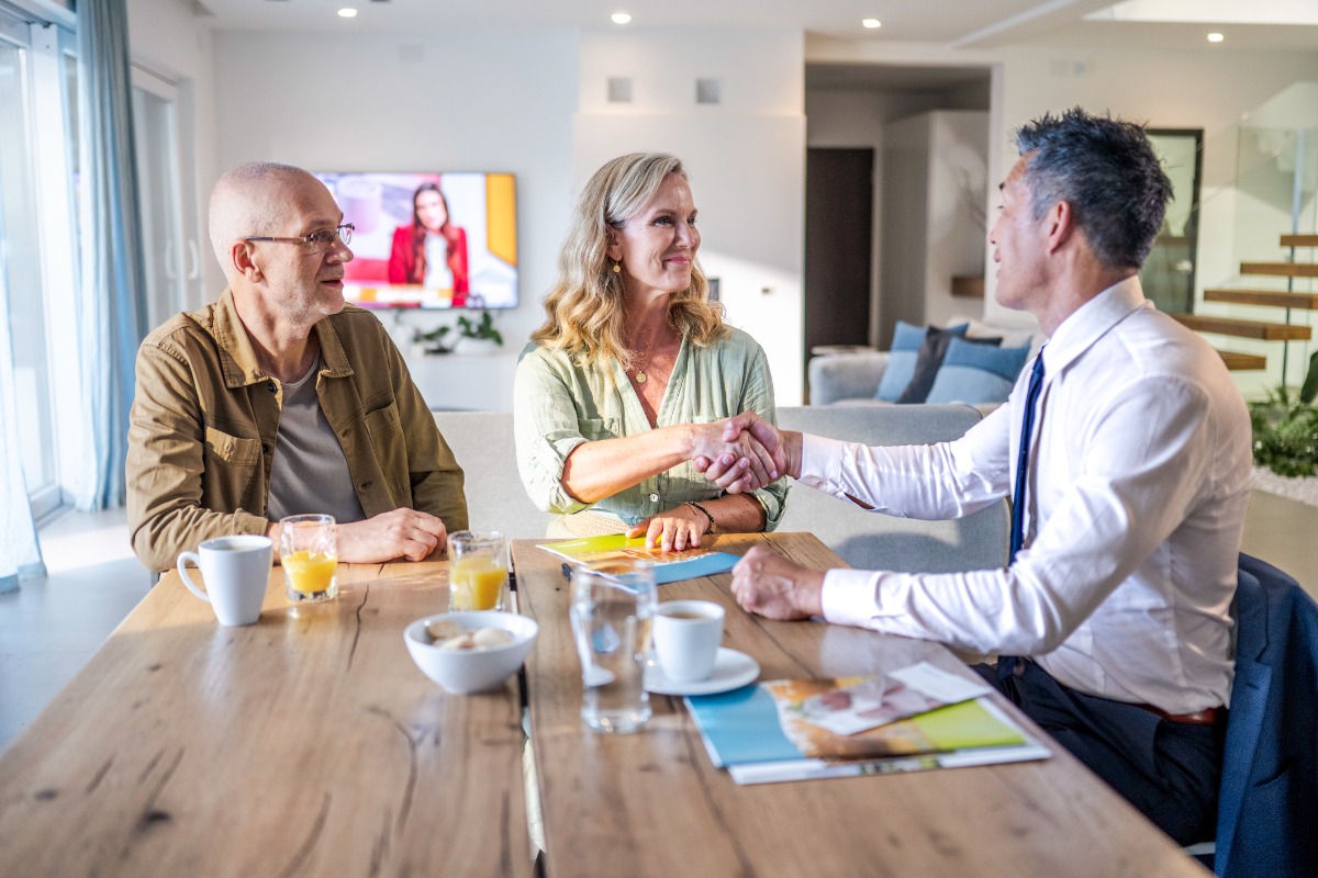 Couple and real estate agent handshake